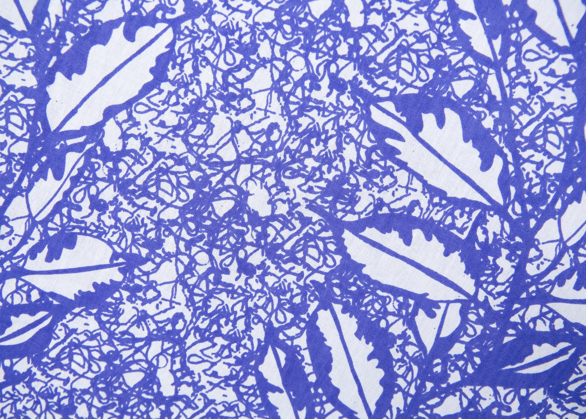 Close up display of violet and white leaf print dress