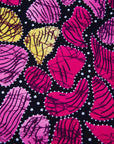 Close up display of black, white, yellow, brown, pink, hot pink and purple bubble print dress