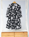 Display of  black dress with white and gray leaf print