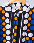 Display of black, white, orange and blue mixed pattern kanga shirt