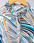 Display of white, black, orange, blue, aqua and brown abstract print dress