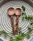 Display of long twisted wooden spoons