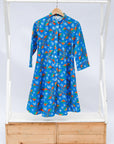 Display of a blue, red and white flower pod design shirt dress