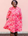 model wearing a pink and white geometric print dress