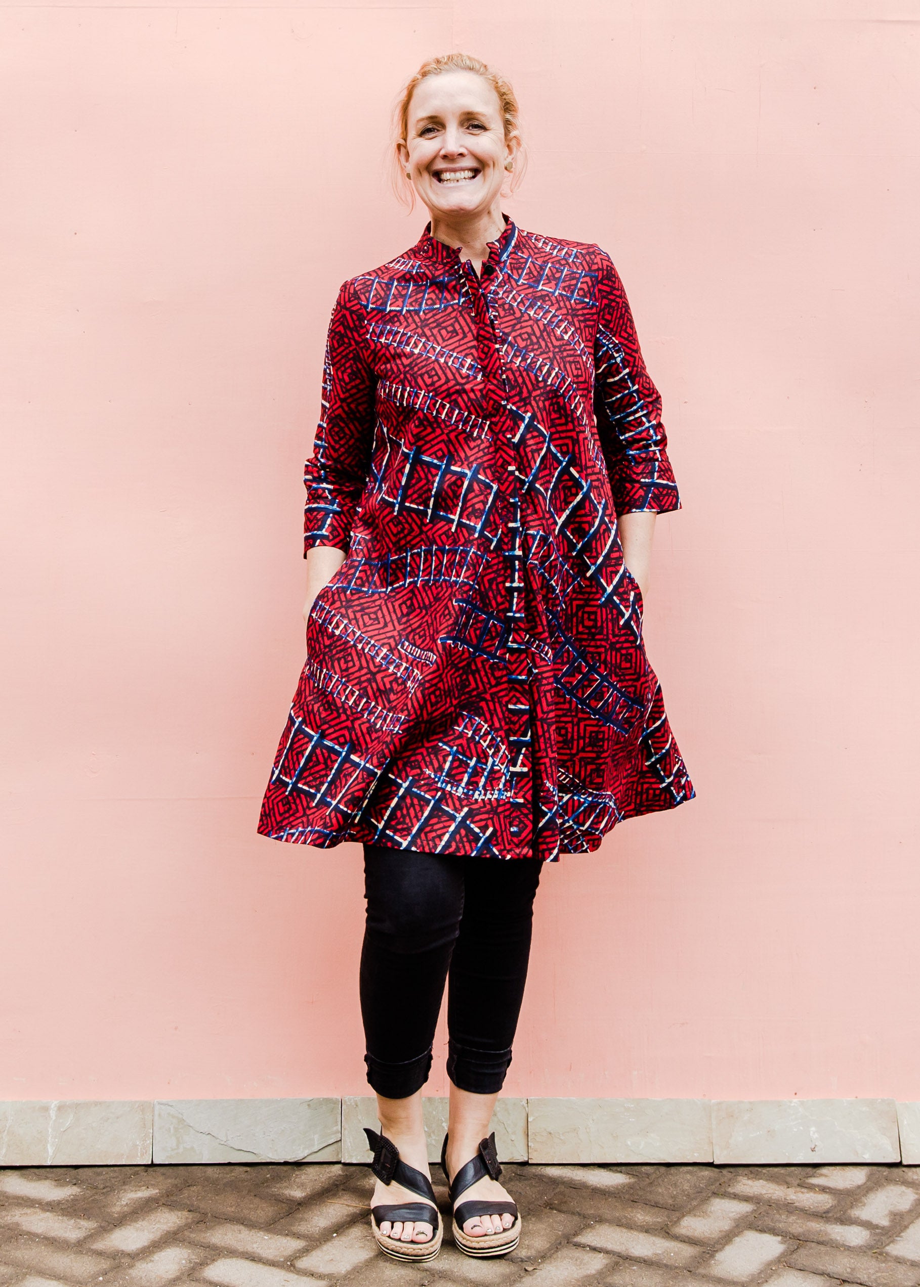 model wearing a red ladder design dress