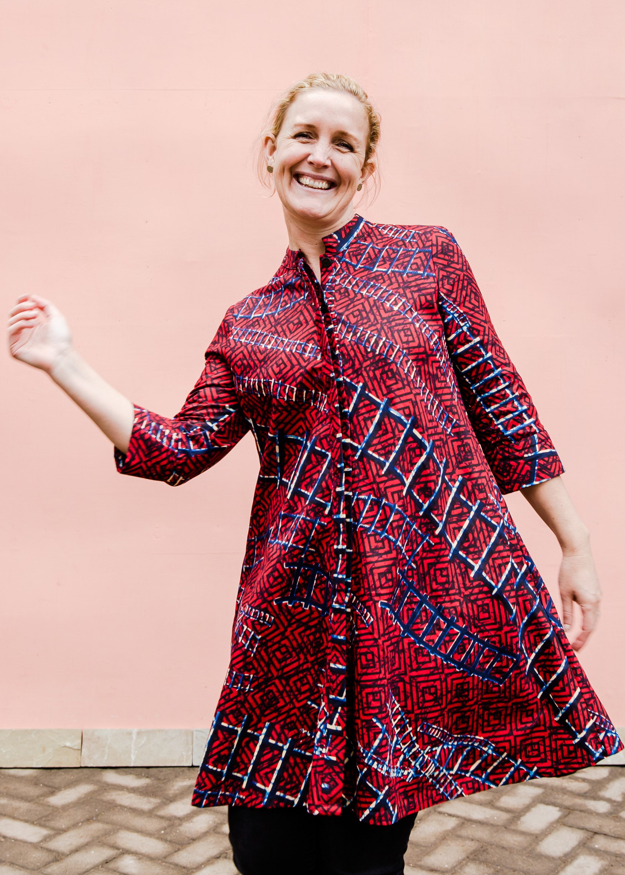 model wearing a red ladder design dress