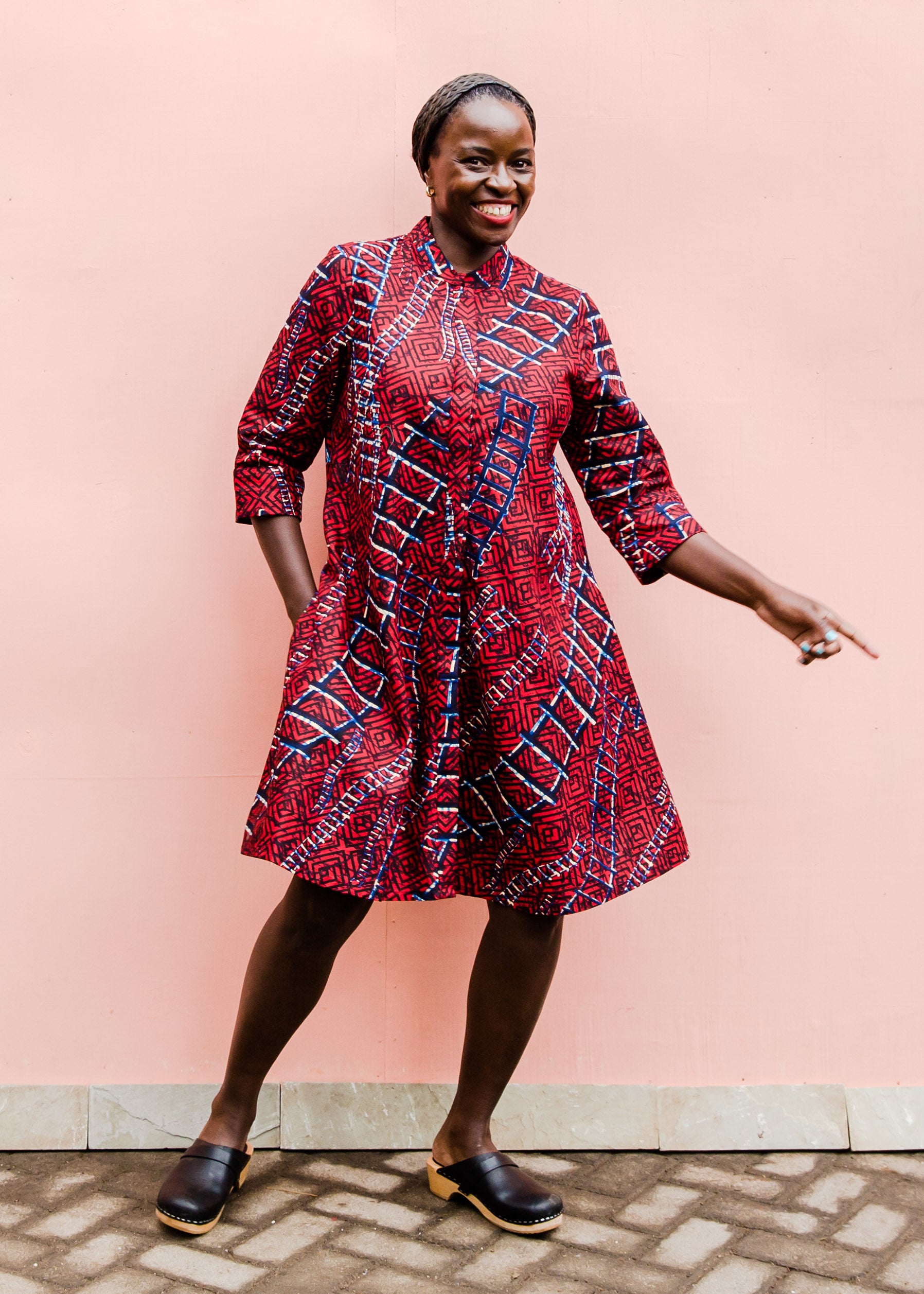 model wearing a red ladder design dress