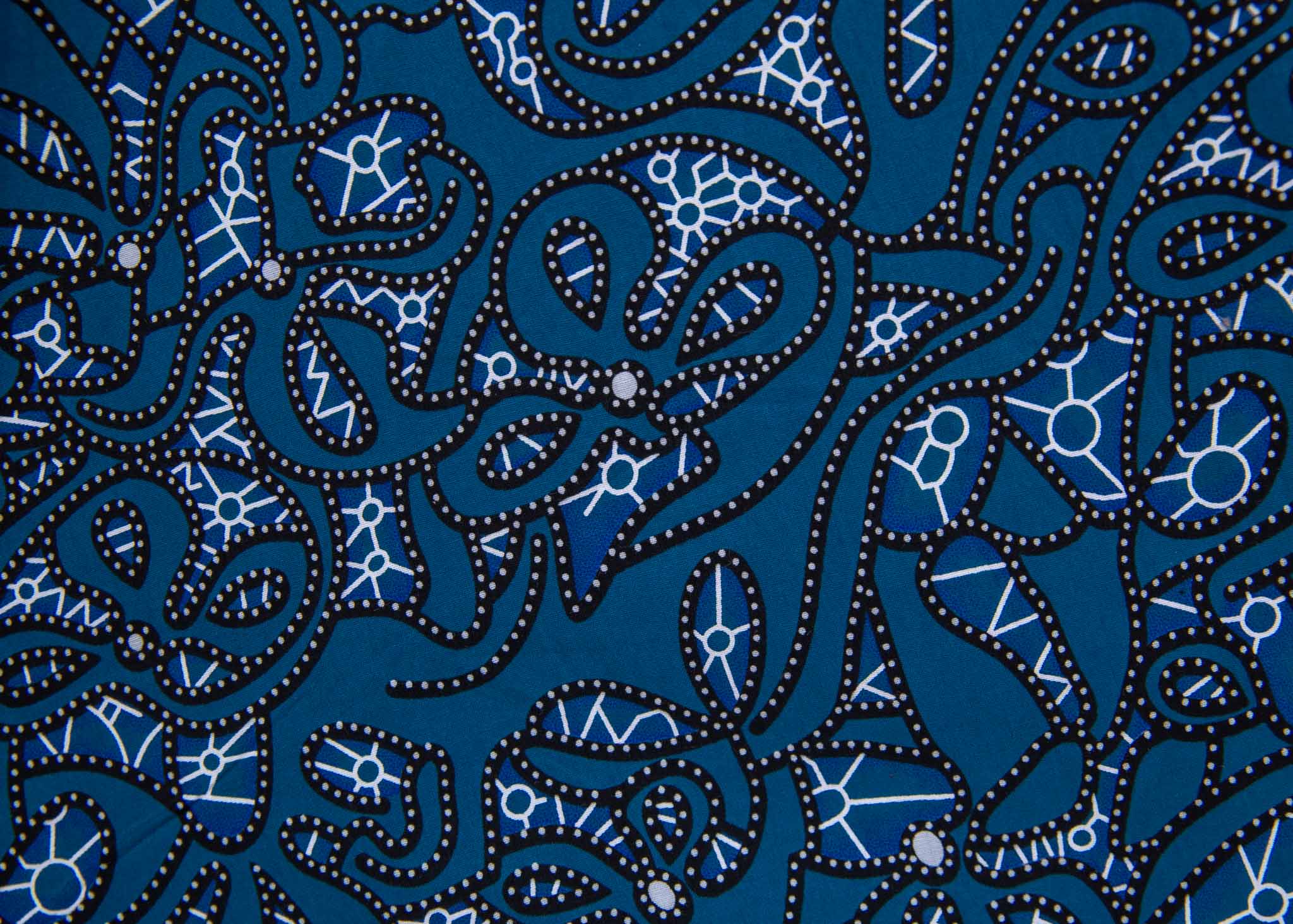 Close up of blue dress with black and white graphics.