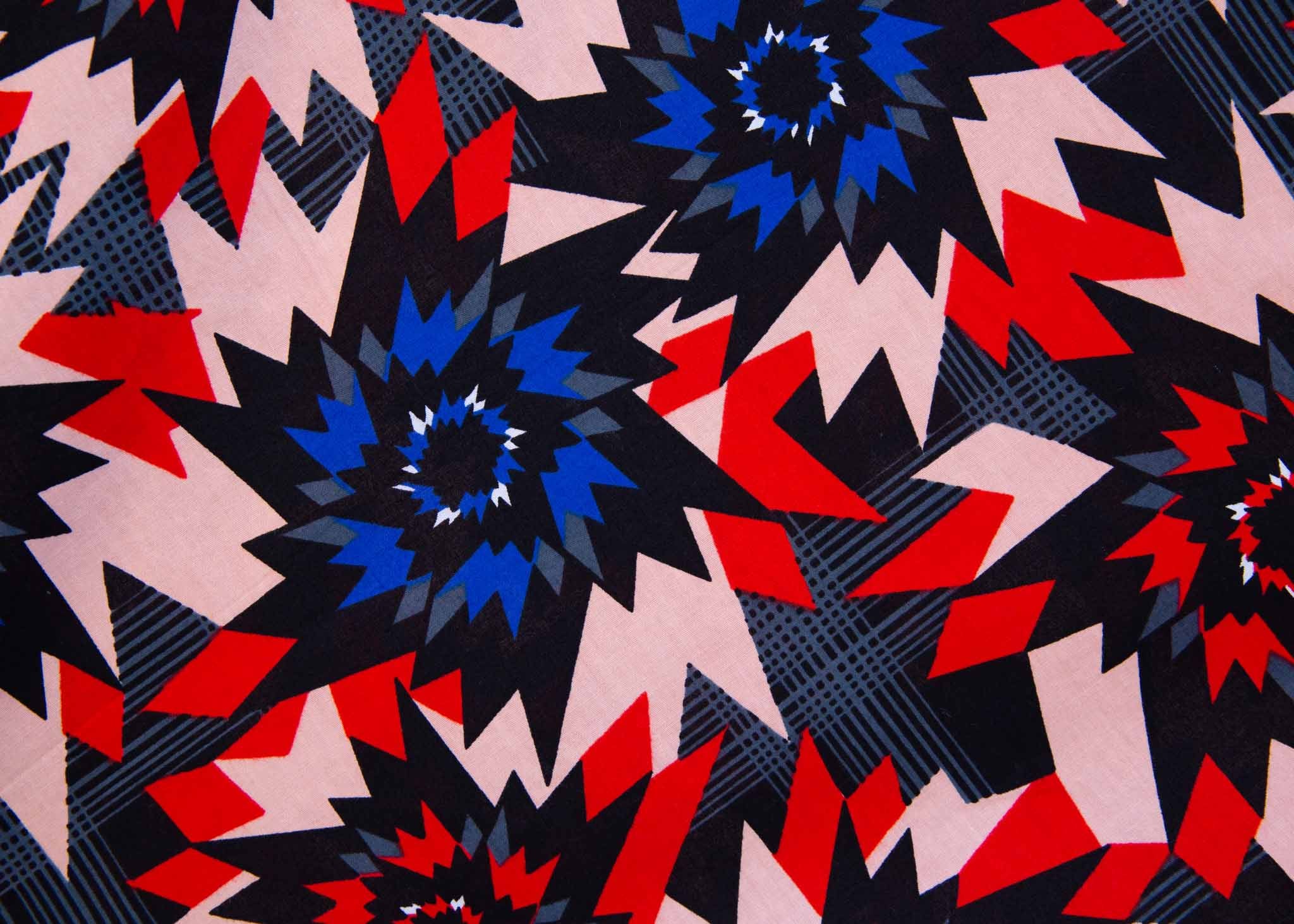 display of a blue, red, black and beige pinwheel design dress