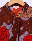 Display of a brown, red and beige floral design dress