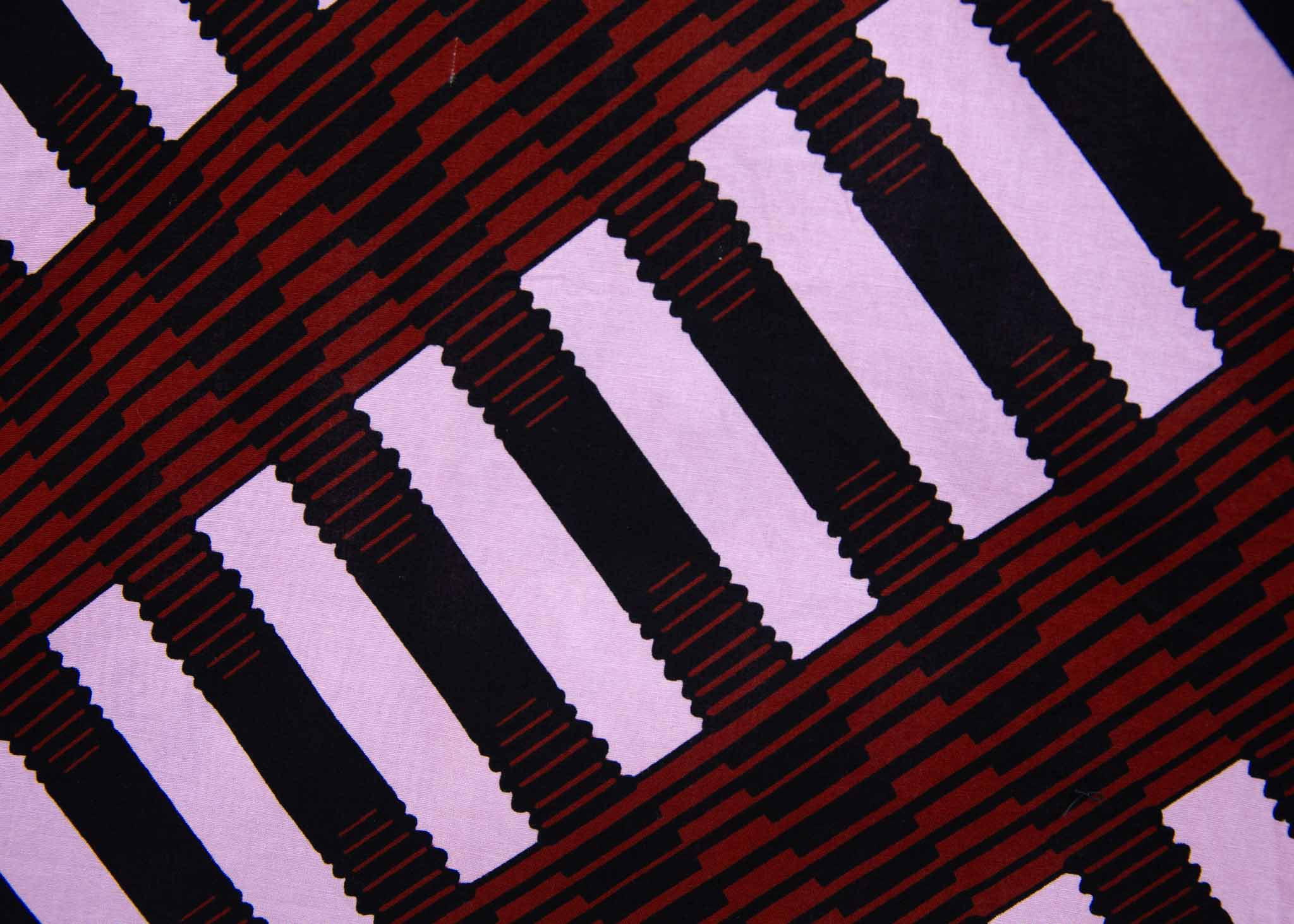 Close up display of pink and brown striped dress, fabric.