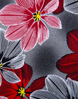 Close up display of dress with large grey and red flower print, fabric.
