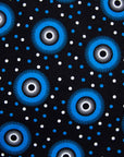 Close up Display of black sleeveless dress with blue and white circle print, fabric.
