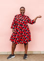 Model wearing red, black and white ribbon print dress.