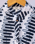 Close up display of white sleeveless dress with black and white zigzag print.