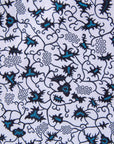 Close up display of white sleeveless dress with blue floral print, fabric.
