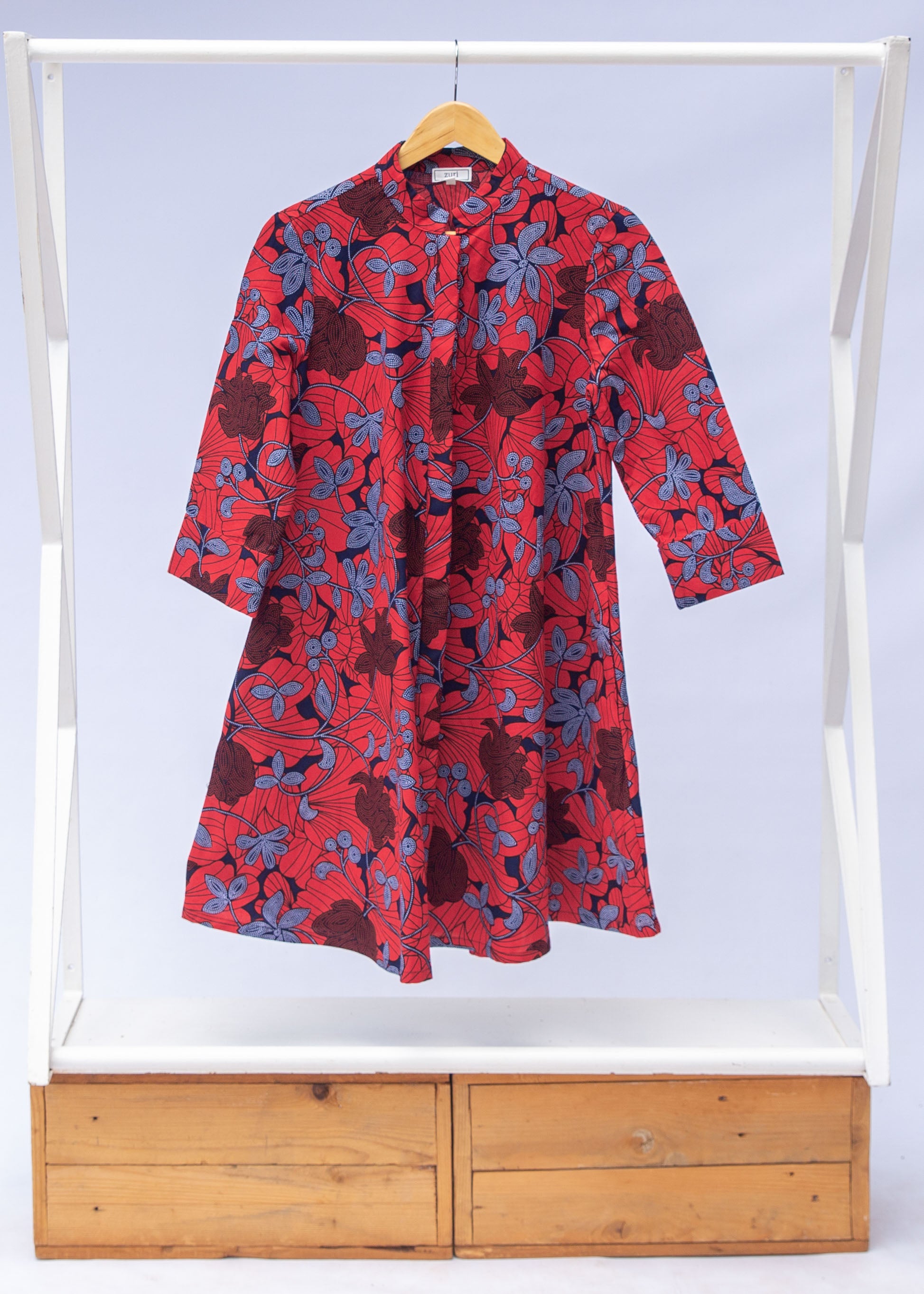 display of red dress with floral vine print.