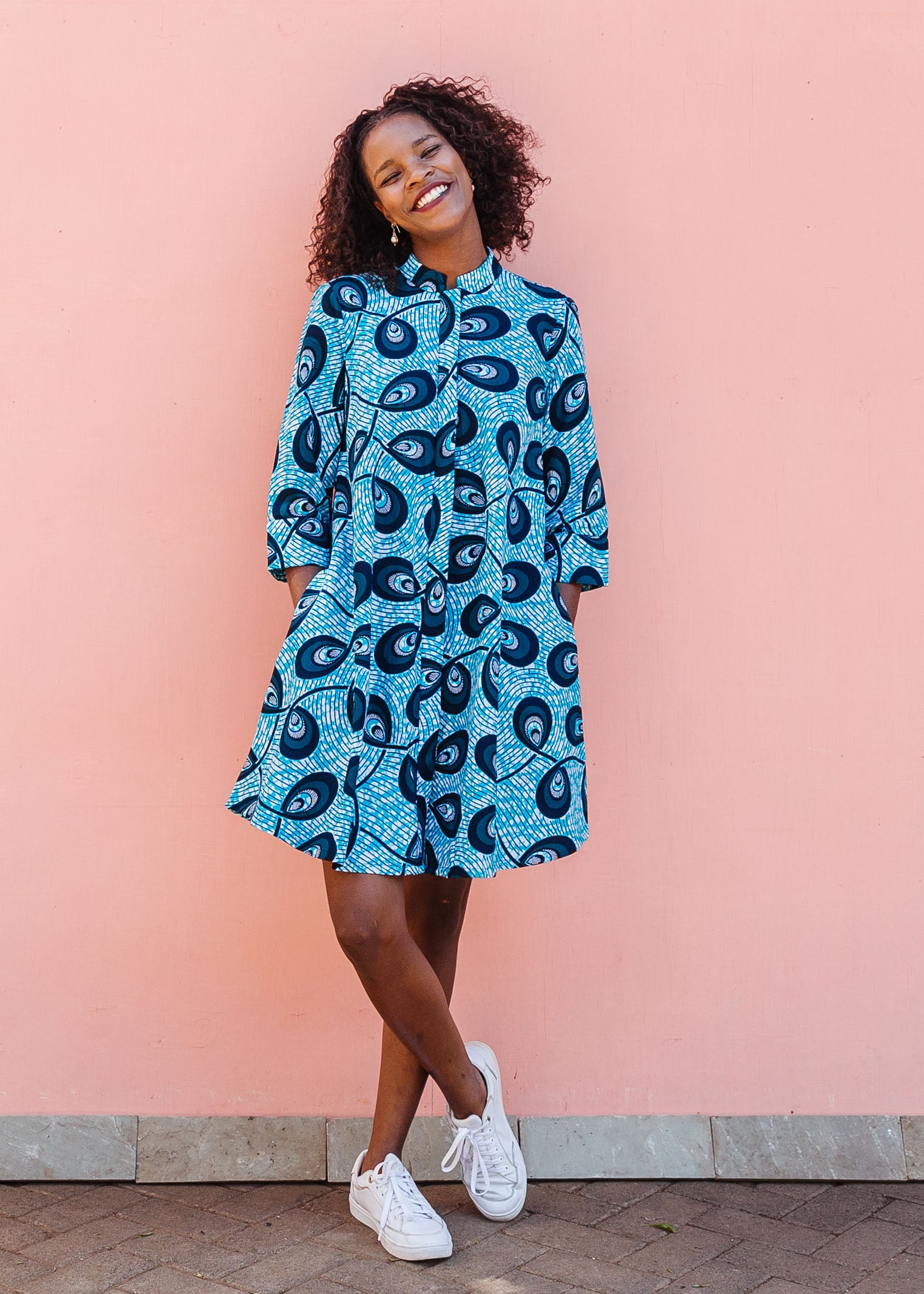 Model wearing blue dress with loop print.
