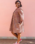 Model wearing red, navy and white mosaic print dress.