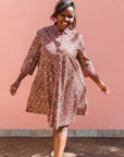 Model wearing red, navy and white mosaic print dress.