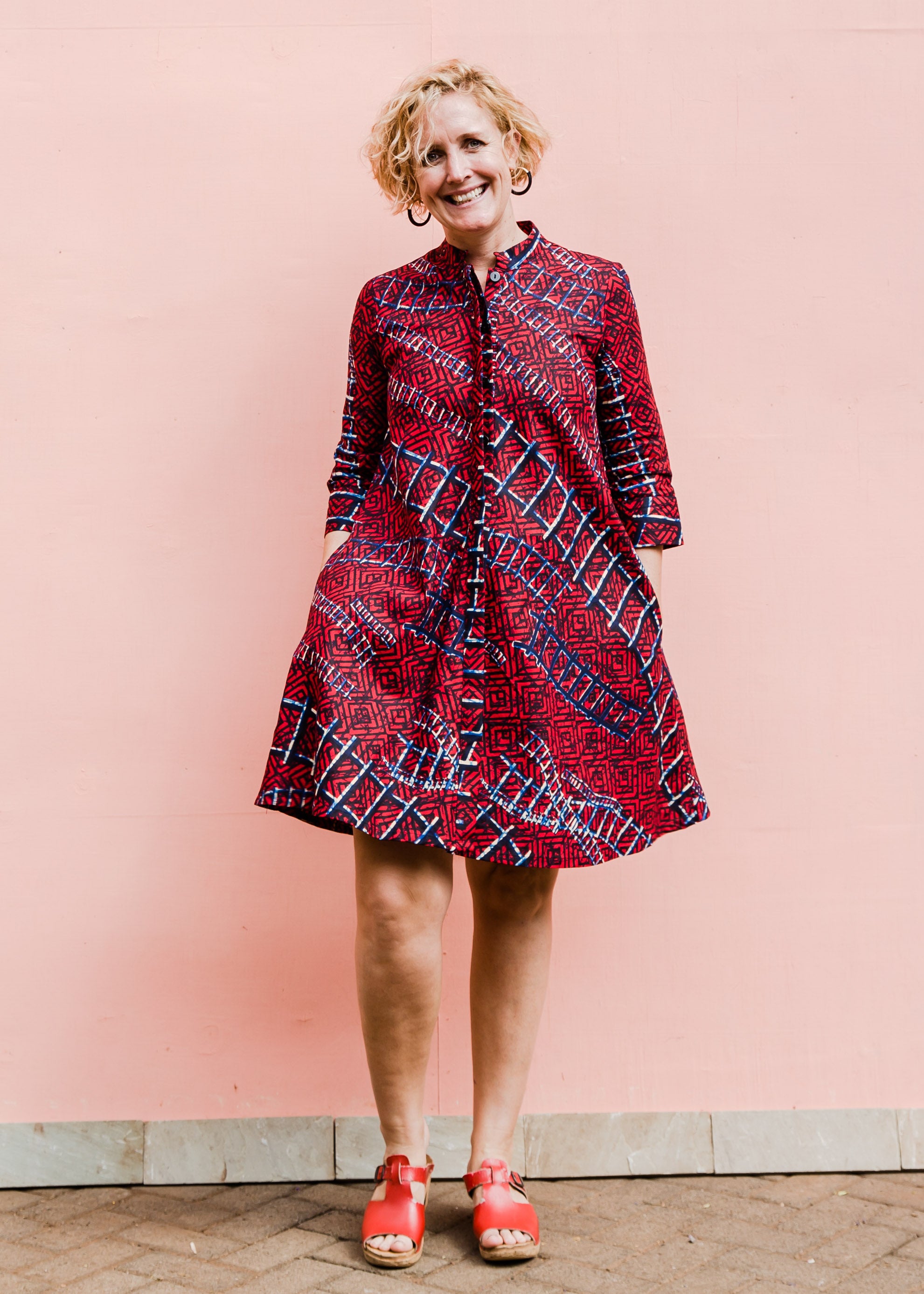 model wearing a red ladder design dress