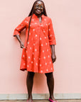 model wearing a red ikat dress