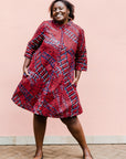 model wearing a red ladder design dress