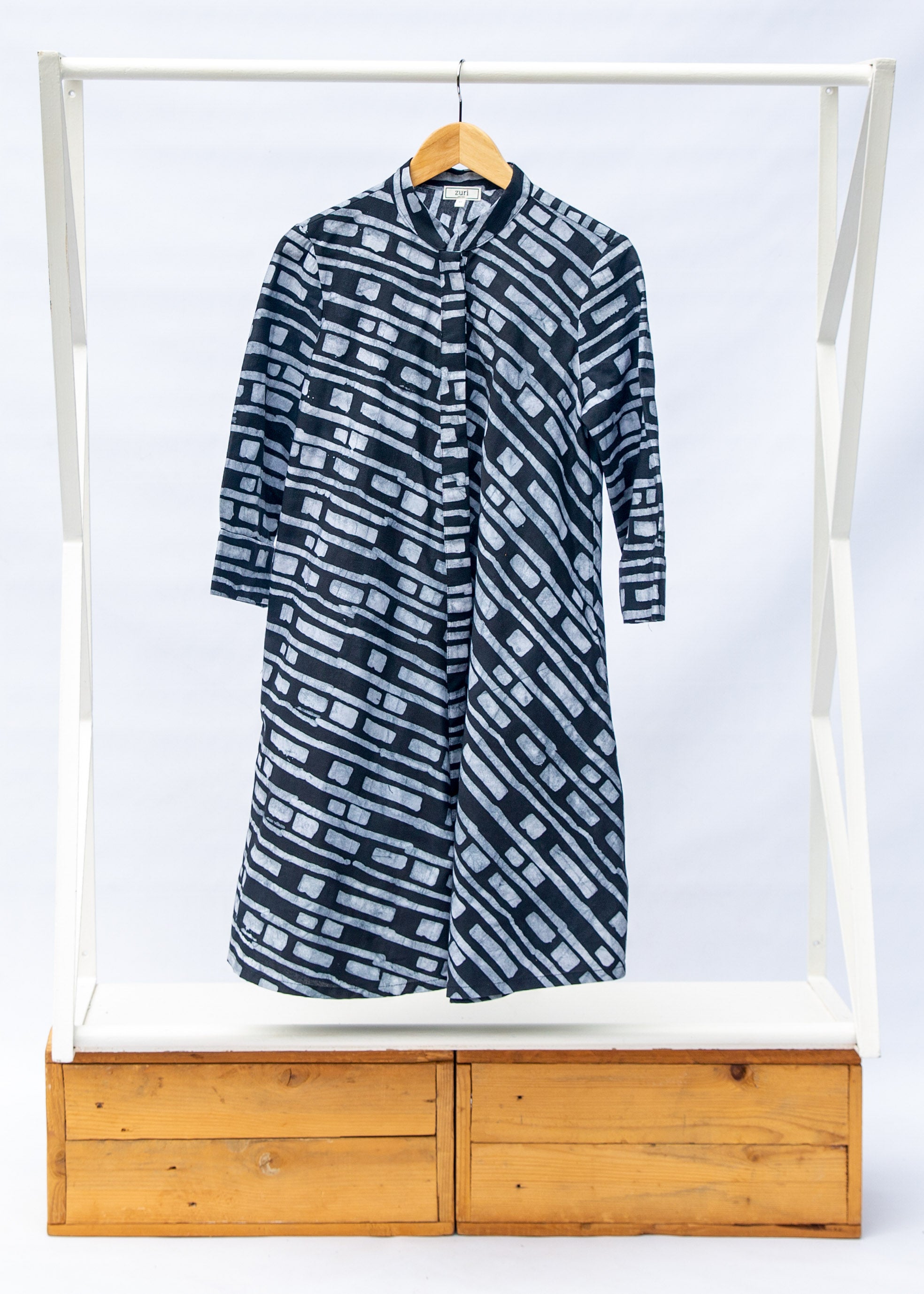 Display of black dress with white lines print.