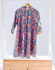 Display of a lavender, blue and orange fiddlehead fern design dress