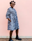 model wearing a black and white palm tree design dress