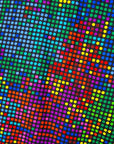 Close up display of rainbow pixelated print dress. 