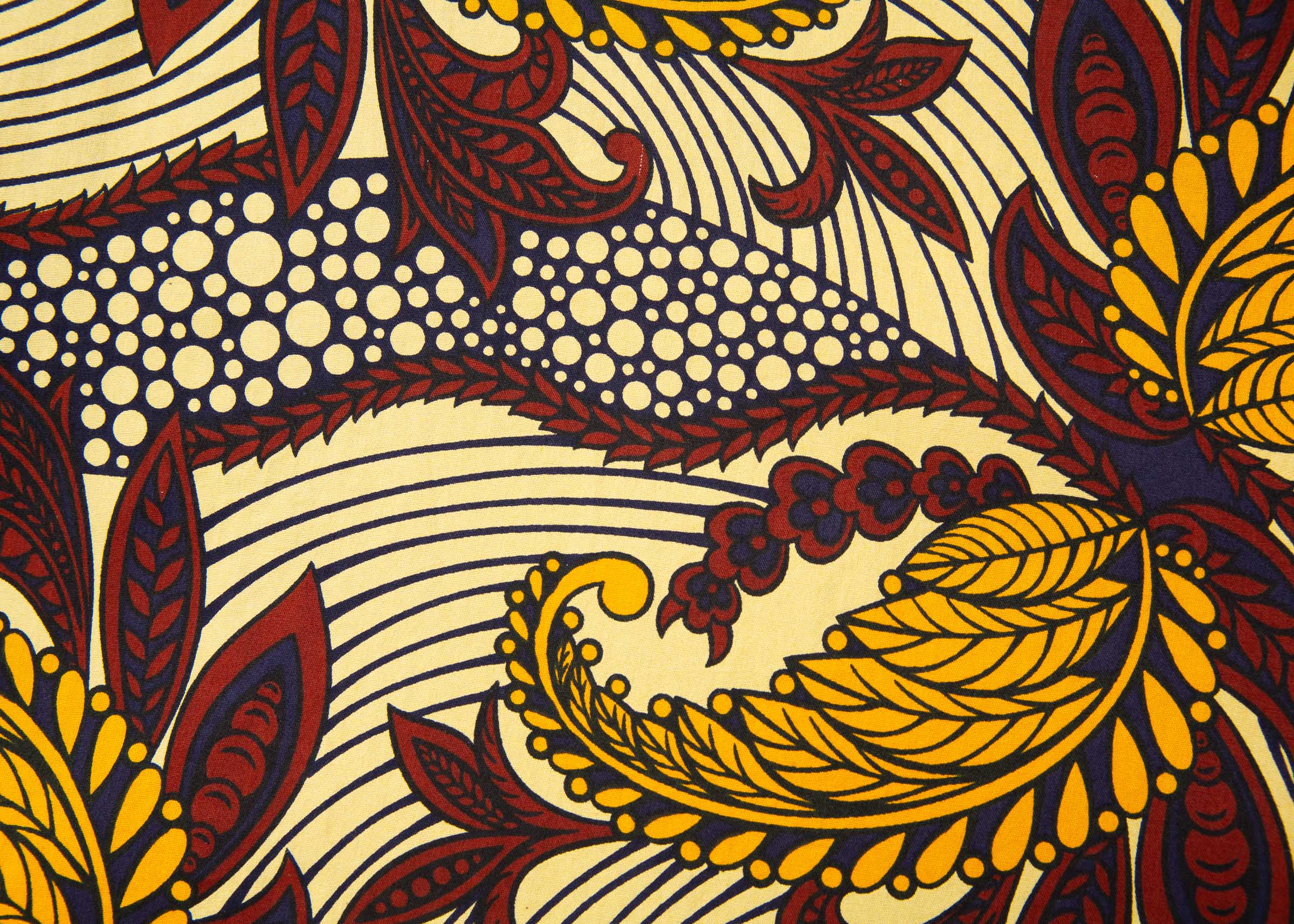 Close up display of paisley print dress with hues of brown.