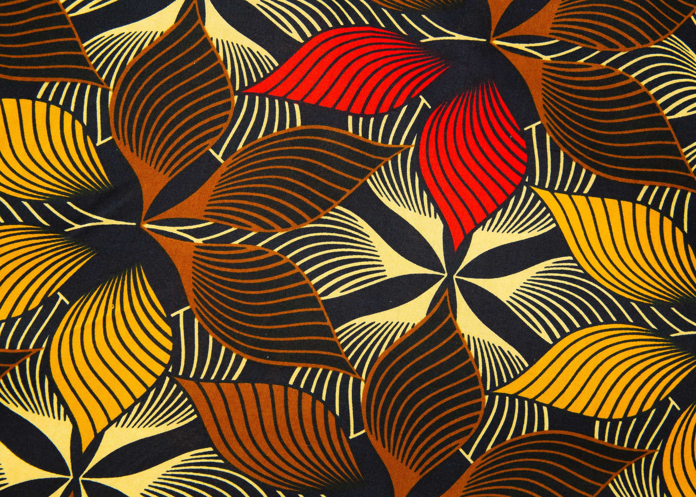 Close up display of brown, yellow, red and black leaf print, fabric.
