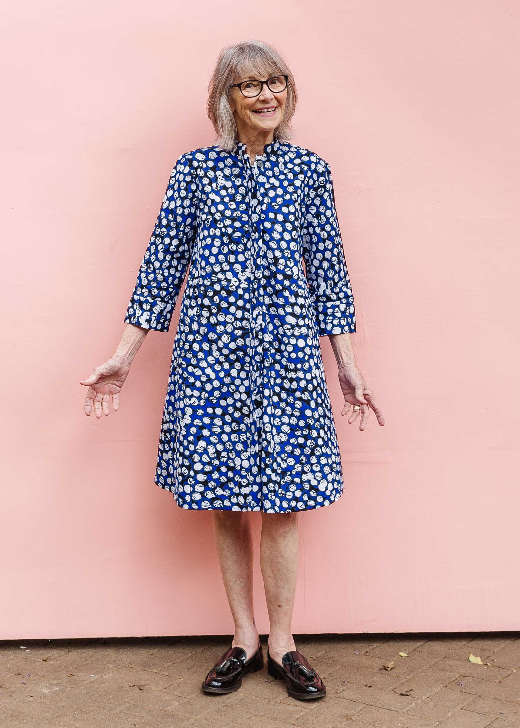 Model wearing blue dress with black and white abstract dots