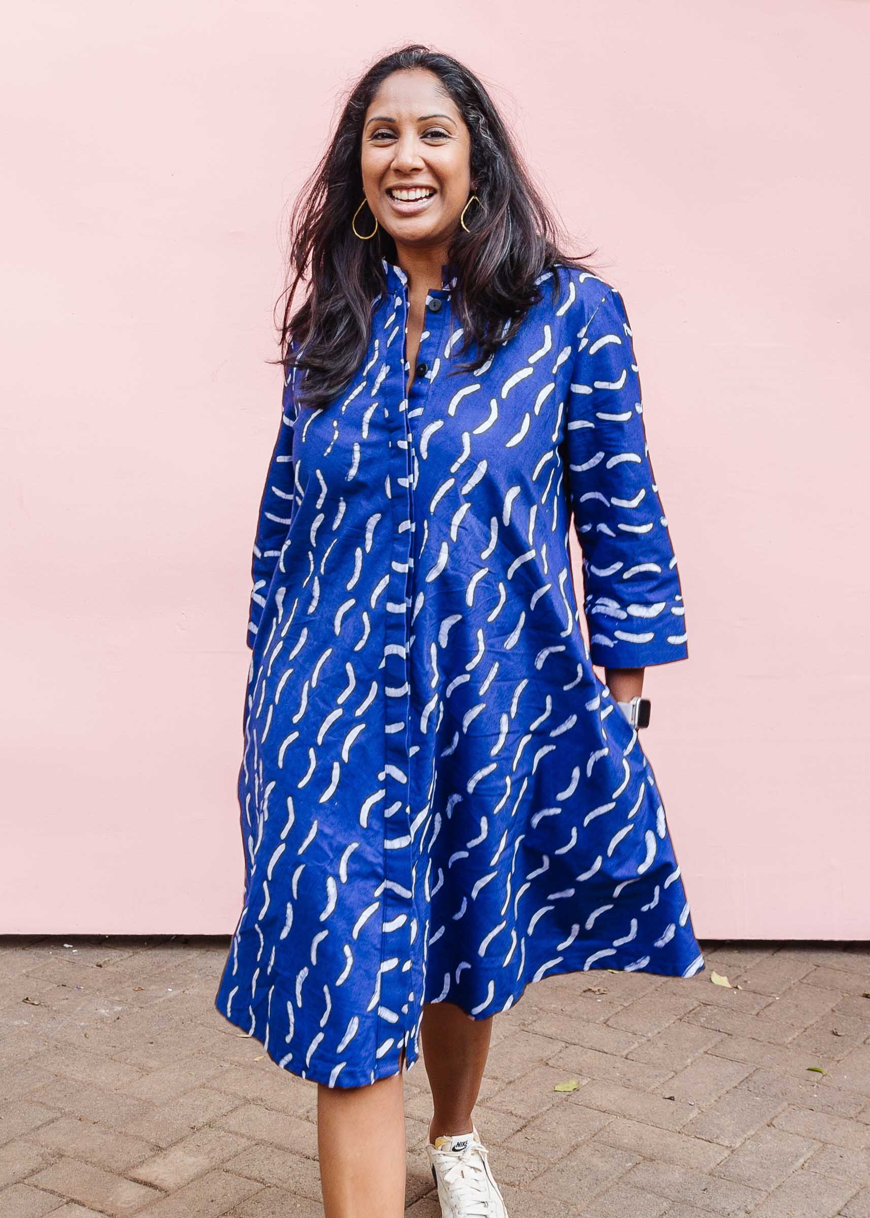 The model is wearing blue and white batik dress.