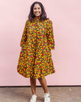 The model is wearing black dress with yellow and red small blob print.